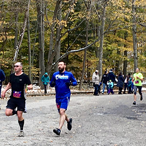 people running race in autumn woods